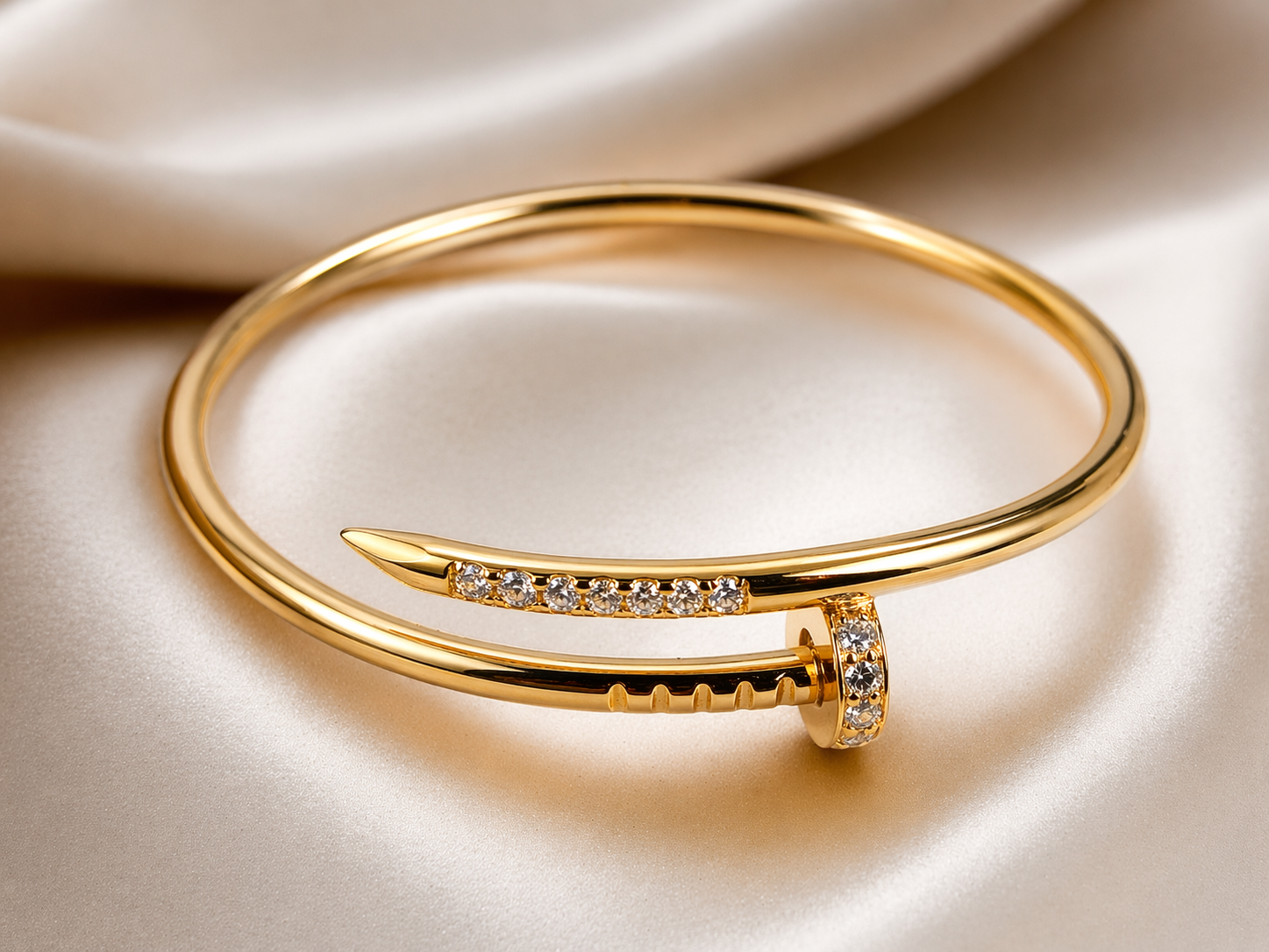 Minimal. Elegant. Powerful.  This sleek nail-inspired bangle in 925 silver with rich gold plating is adorned with shimmering zircon stones — designed for the woman who loves subtle luxury