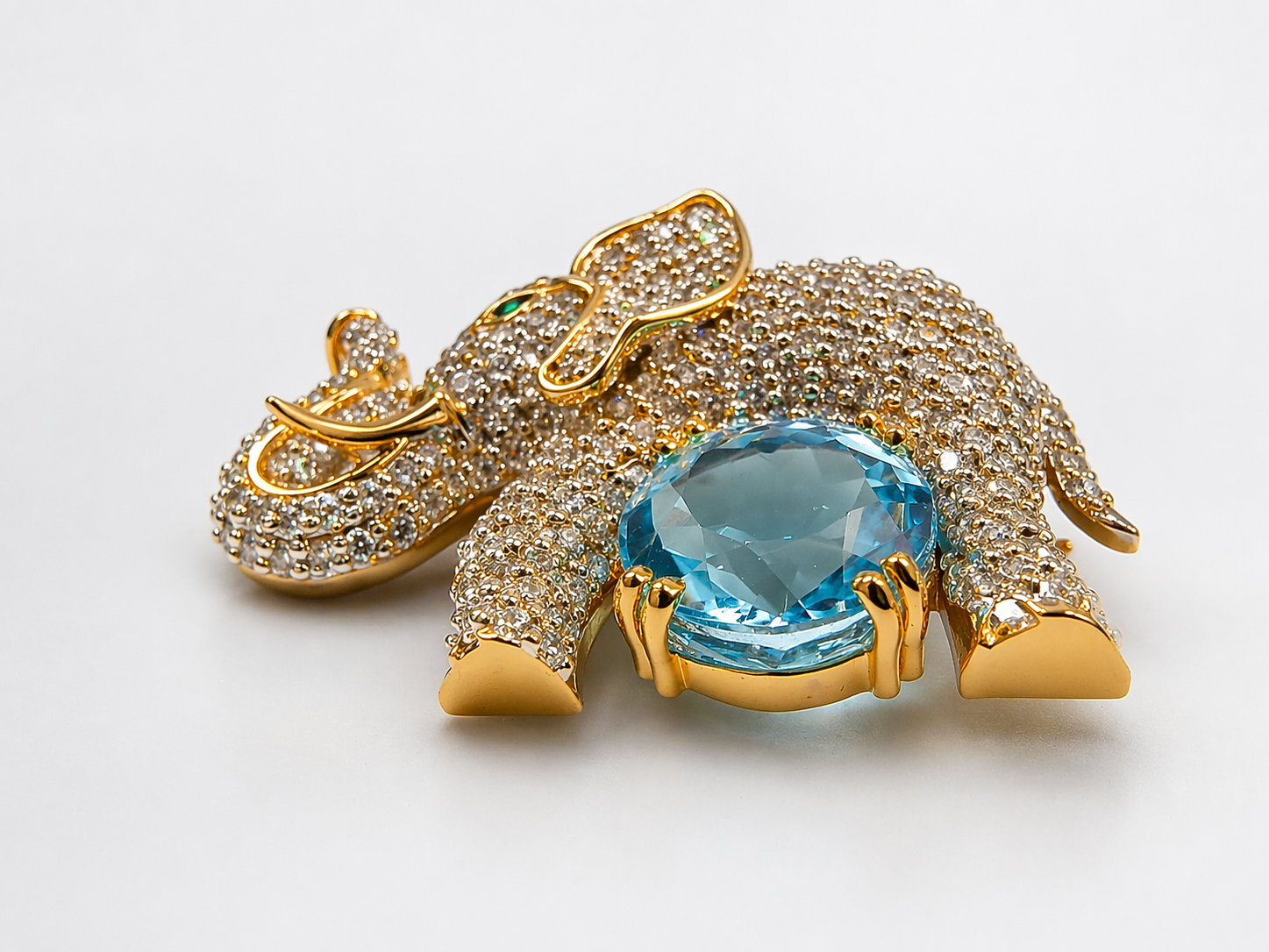 Handcrafted in 925 silver with premium gold plating, this zircon-studded elephant brooch with blue topaz gives a high-end designer look — without the heavy price tag