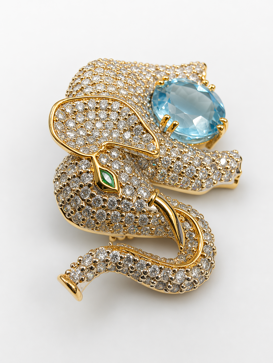 Handcrafted in 925 silver with premium gold plating, this zircon-studded elephant brooch with blue topaz gives a high-end designer look — without the heavy price tag