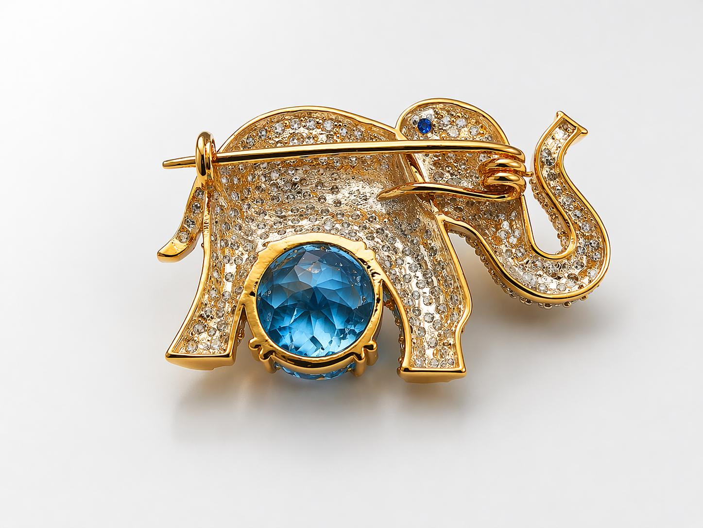 Handcrafted in 925 silver with premium gold plating, this zircon-studded elephant brooch with blue topaz gives a high-end designer look — without the heavy price tag